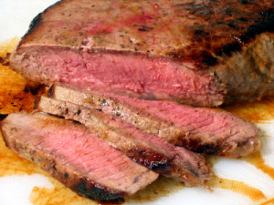 Juicy London Broil sliced on cutting board