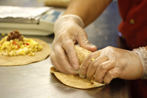 hands wrapping a burrito
