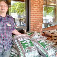staff with the pile of compost bags