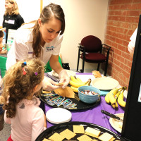 woman making snacks with kids