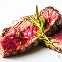 slice of steak with sprig of rosemary