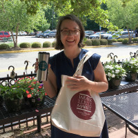 Amy Crump holding a WSM mug and bag