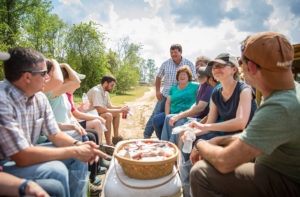Weaver Street staff rides around the farm on a cart