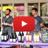 men pouring Riojana wine with video icon
