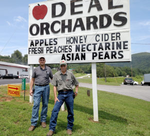 Orchard sign with two men