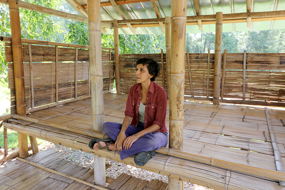 Nicole sitting in bamboo house