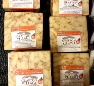 packages of cheese in the store cooler
