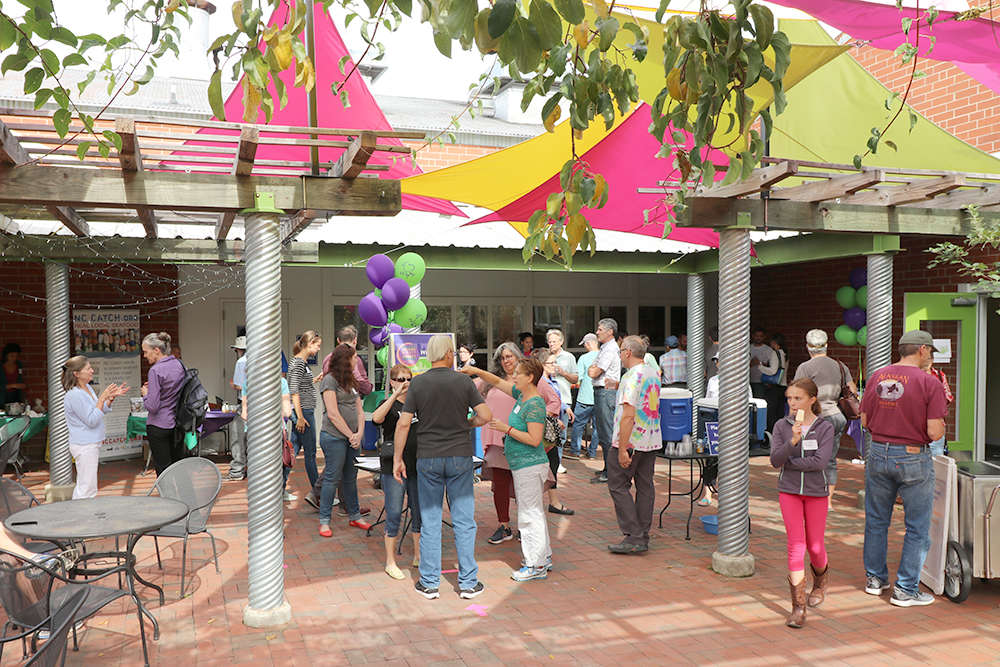People gathered on the patio at the Weaver Street Food House