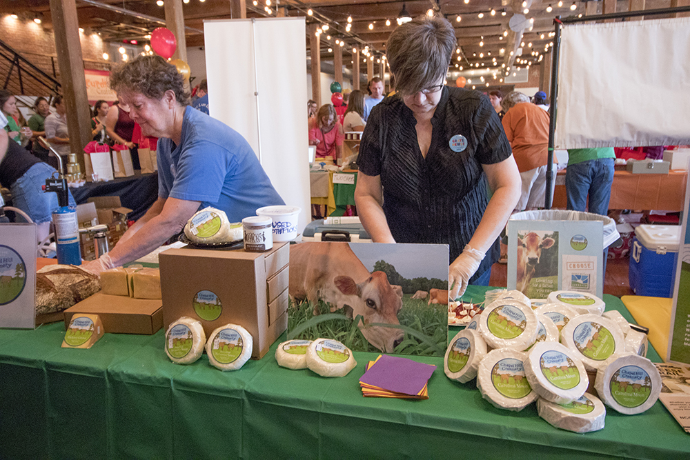 people cutting cheese at Curds & Crafts
