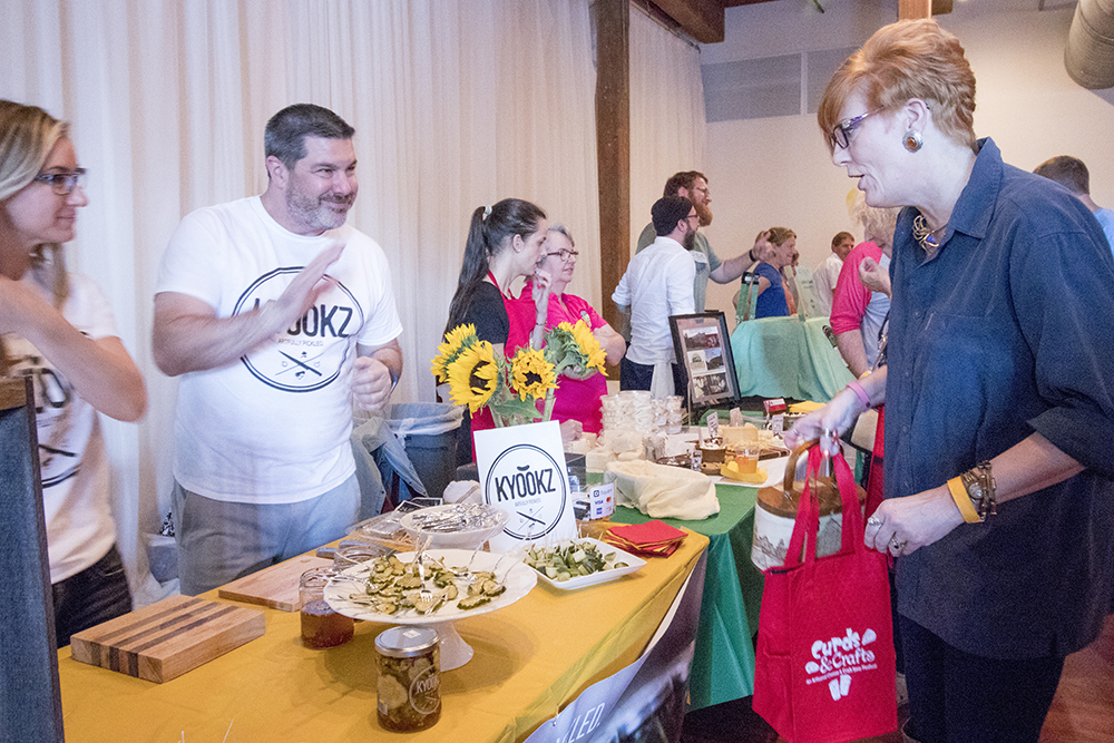woman samples pickles at Curds & Crafts