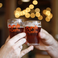 Glasses toasting at Curds & Crafts