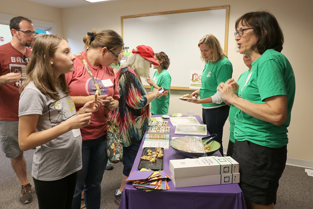 Four women explain PORCH to visitors