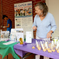 woman serving pickled shrimp at Co-op Fair