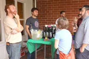three men pouring wine samples