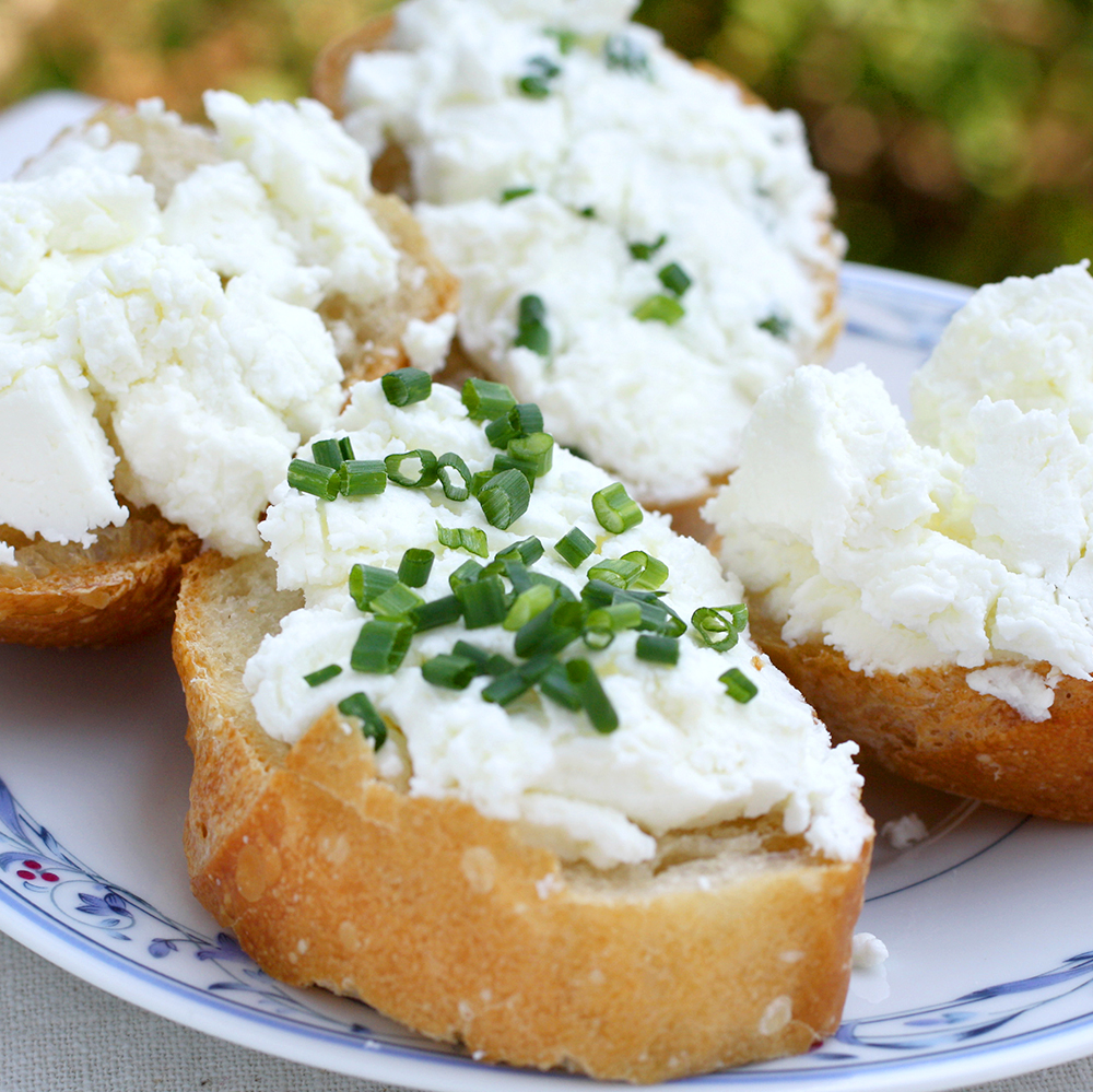 goat cheese on bread, sprinkled with chives
