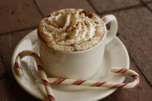 cocoa drink with whipped cream and candy canes