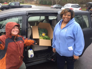 two people with food packed into a car