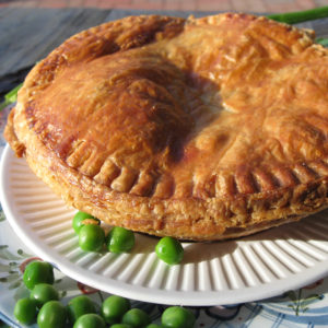 pot pie on plate with vegetables