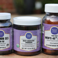 three bottles of vitamins with a Weaver Street label