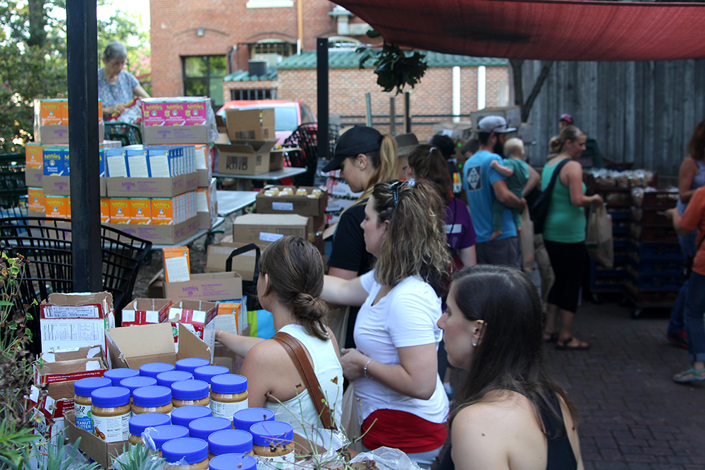 People sorting food on the patio at Weaver Street in Carrboro