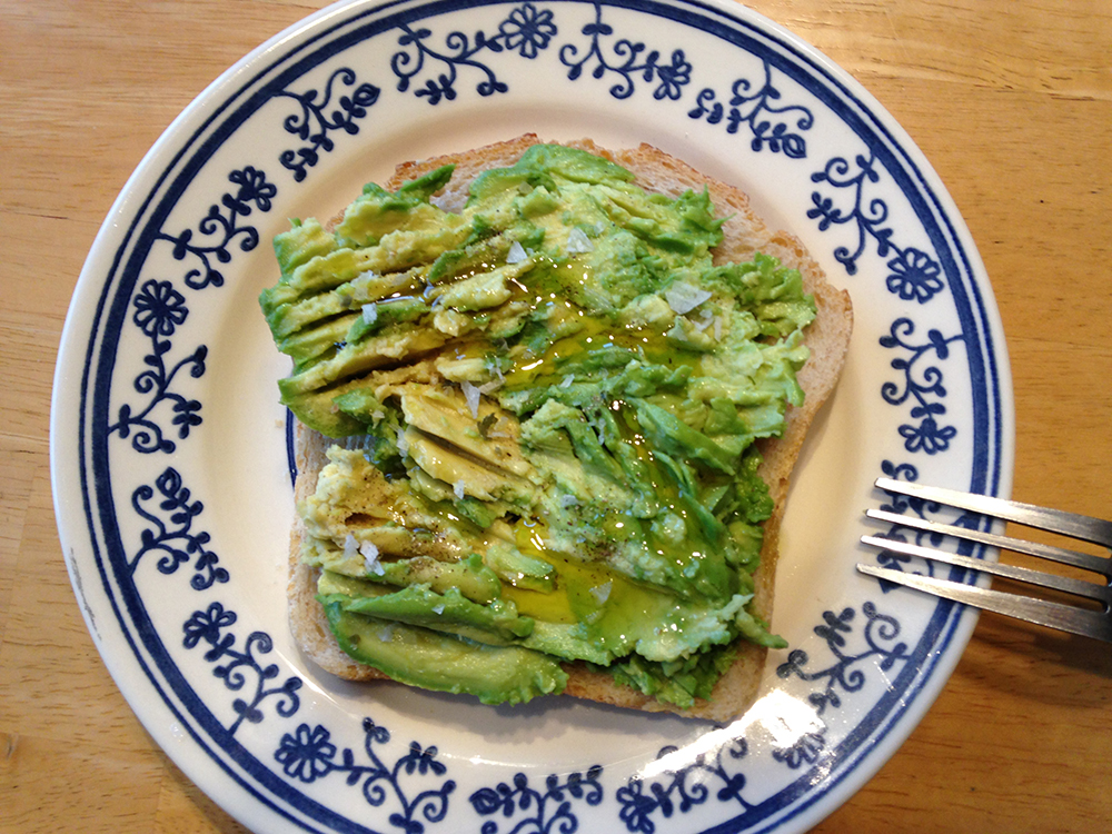 slice of toast with mashed avocado on plate