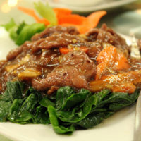 beef stew on plate with greens