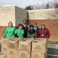 a team of people standing by boxes