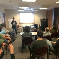 carolyn talks to a room full of staff members