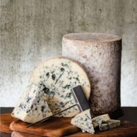 wedges of blue cheese on a cutting board