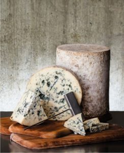 wedges of blue cheese on a cutting board