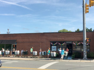 people with shopping carts of food lined up outside TABLE's office building