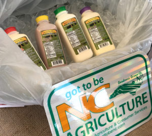 four bottles of milk in basket