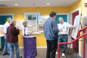 Ruffin explains posters of raleigh store