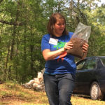 Laura holding a bag of sawdust