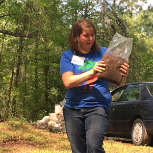 Laura holding a bag of sawdust