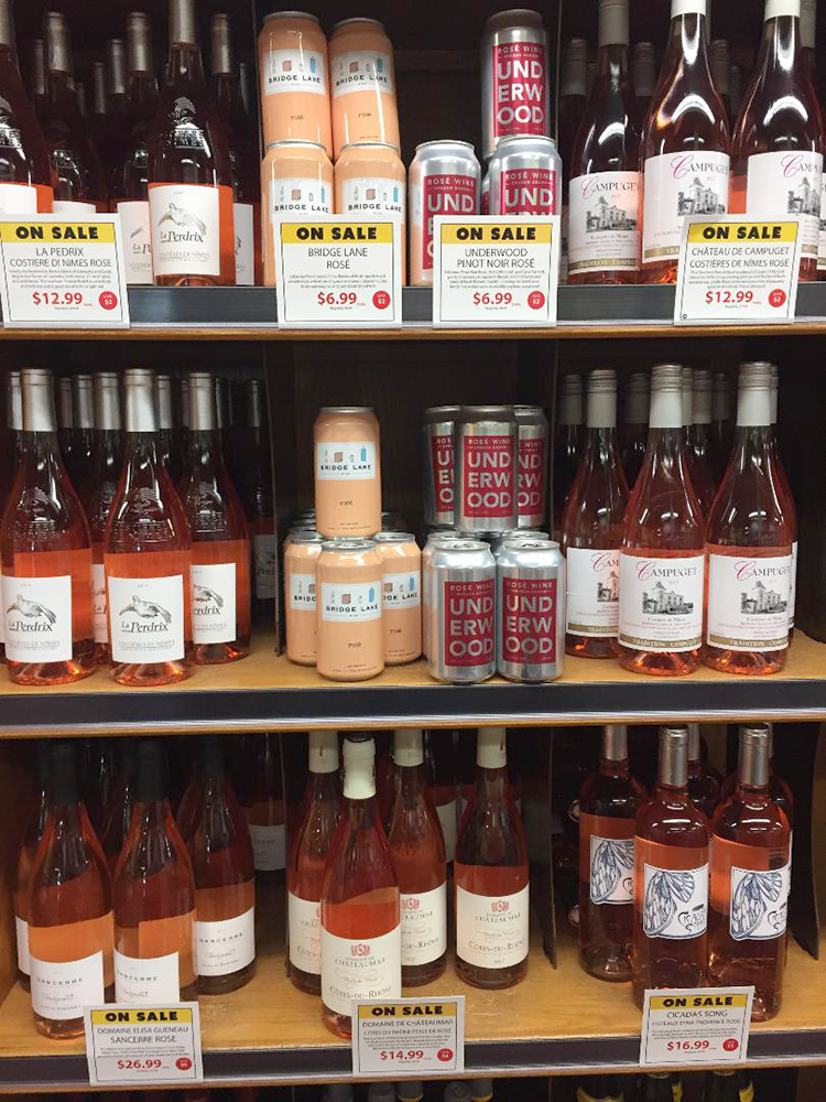 cans and bottles of rose wine on a shelf
