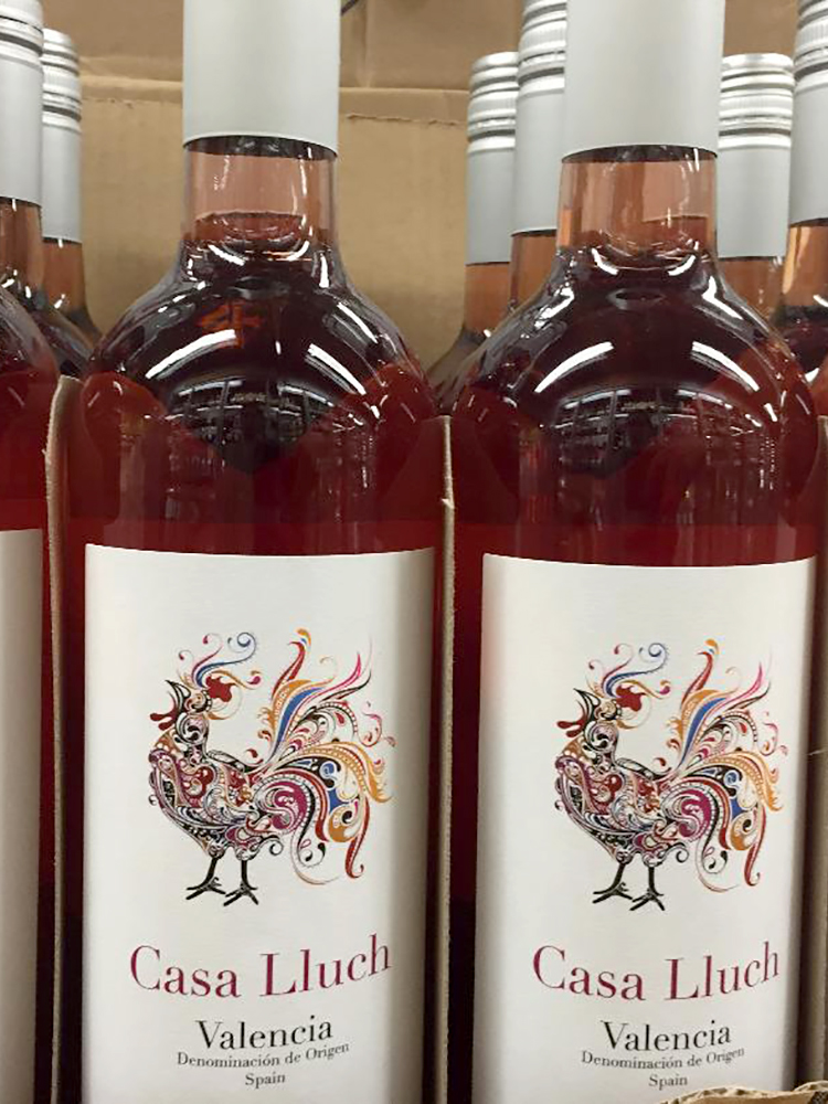 rose wine bottle with a rooster drawing