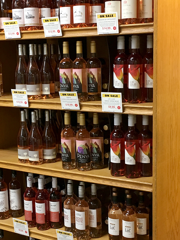 bottles of rose wine on a shelf