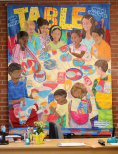 mural of children around a table with food