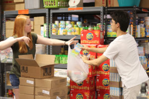 volunteers passing bags to each other