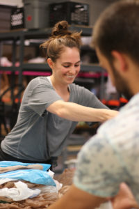 volunteer smiling as she works