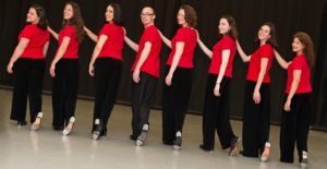 row of tap dancers on a stage