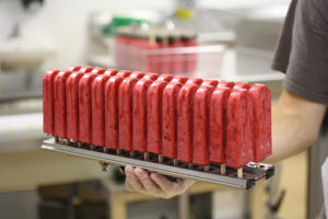 raspberry pops in a holder, just removed from the freezing tank in the production kitchen
