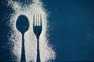 outlines of spoon and fork made with powdered sugar