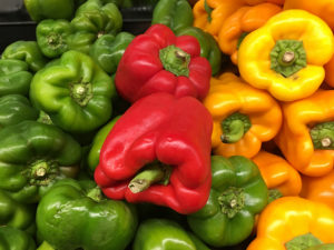 red, green, and yellow bell peppers in a stack
