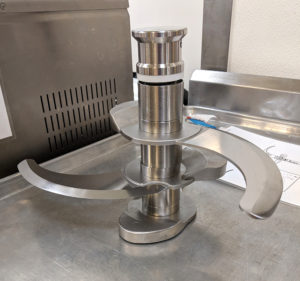 the metal blades of a Robot Coupe food processor