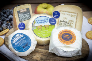 5 cheeses on a board, with labels from North Carolina cheese-makers