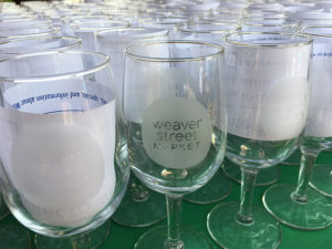 wine glasses etched with Weaver Street logo on table