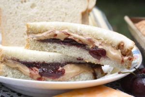 close up of peanut butter and jelly sandwich on white bread