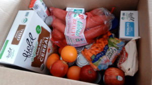box of cereal, fruit, carrots, and more